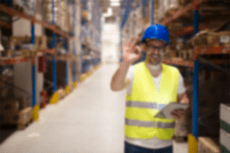 warehouse-worker-standing-large-storage-center-showing-ok-hand-gesture-satisfied-delivering-goods